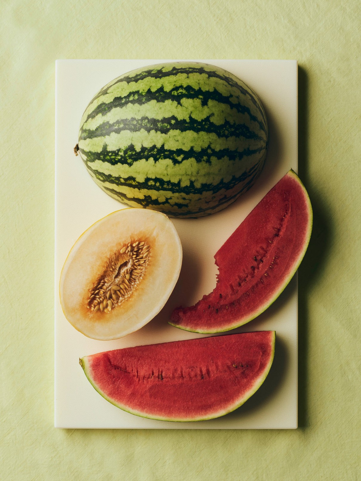 Hay slice chopping board in Ice Lime with chopped melons. 