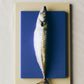 Stacked Hay slice chopping boards with fish. 
