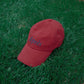 HÔTEL827 Sun Kissed baseball cap in chilli on the grass.