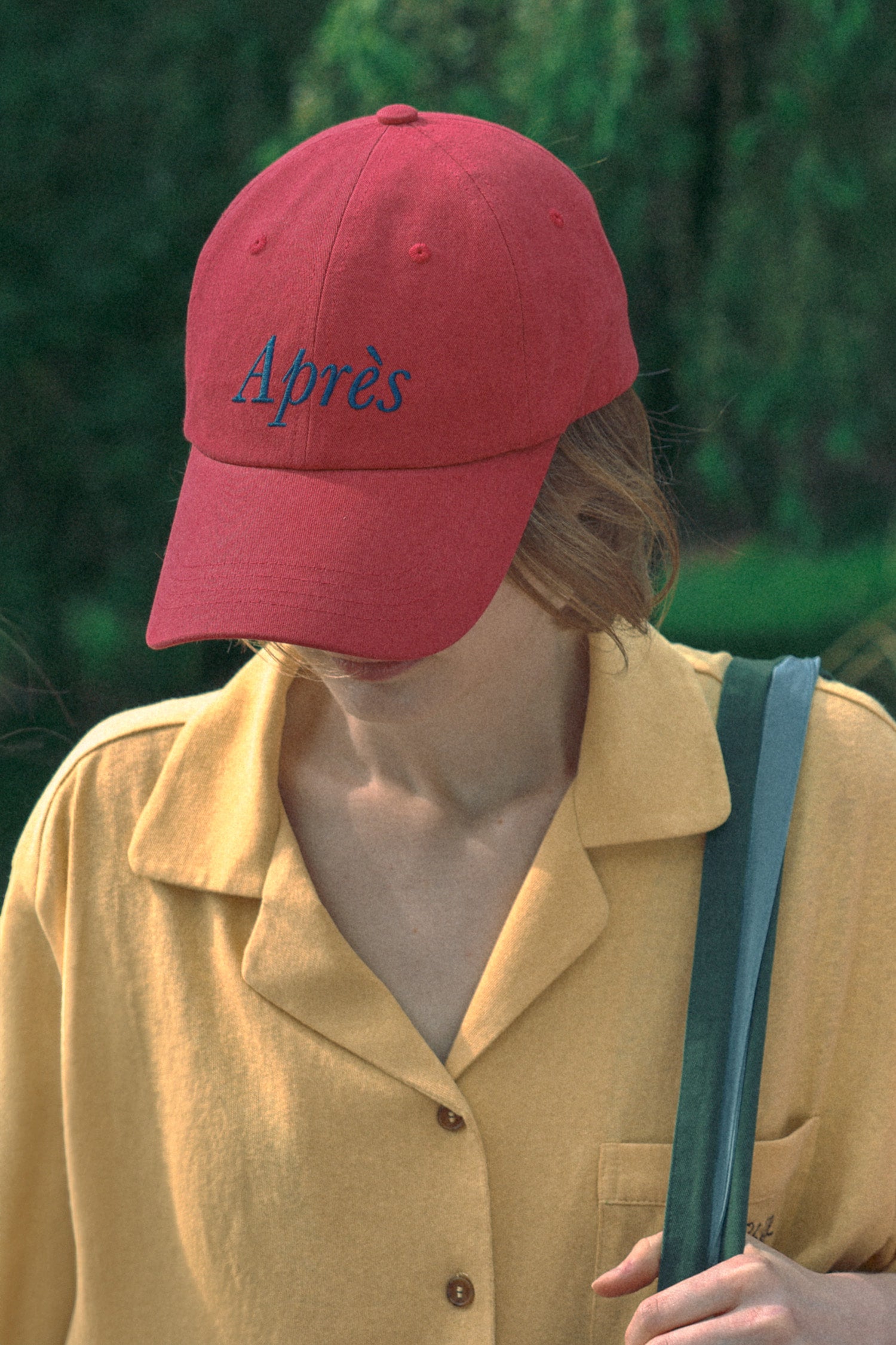 Model wearing HÔTEL827 Sun Kissed Chilli red cotton baseball cap outdoor