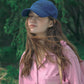 Woman wearing HÔTEL827 Sun Kissed blue baseball cap in casual street style