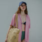Woman wearing HÔTEL827 Sun Kissed blue baseball cap in beach wear, wearing a hotel827 tote over shoulder.