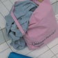 HÔTEL827 Sun Kissed pink canvas tote bag nearby a swimming pool.