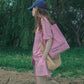 A woman wearing a pink casual wear set, wearing HÔTEL827 Sun Kissed pink canvas tote bag over shoulder
