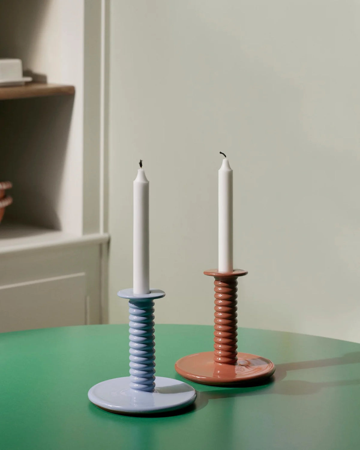 HAY Barro light blue candleholder with lit taper candle on modern dining table