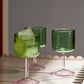 A close up shot of the set of two HAY Tint Wine Glasses in Green and Pink.