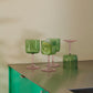 Table setting of the set of two HAY Tint Wine Glasses in Green and Pink.