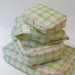 A Stack of Hotel827 Cotton Travel Pouch in Evergreen in different sizes. 