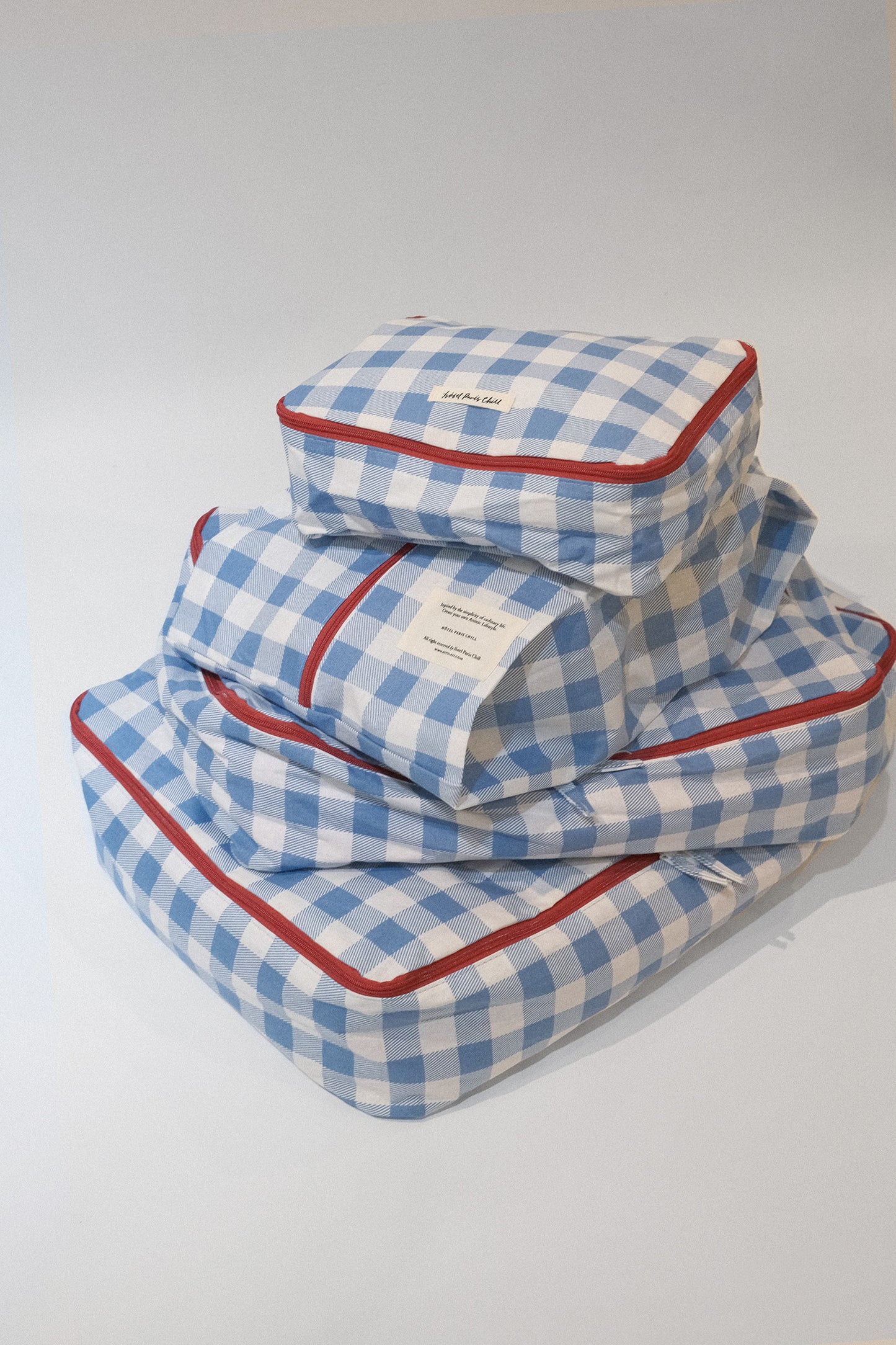 A stack of Hotel827 cotton travel pouch in Ripples, in different sizes. 