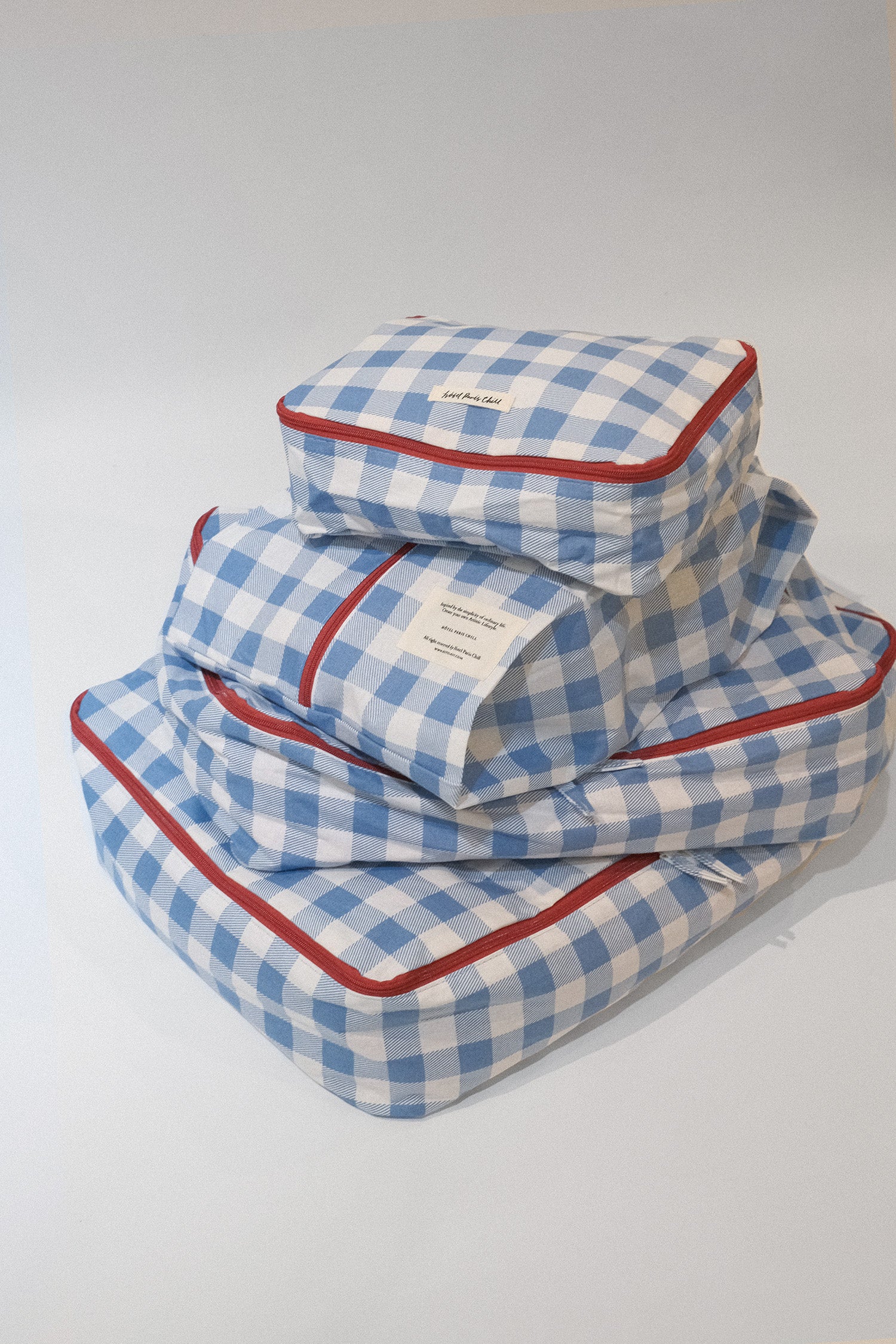 A stack of Hotel827 cotton travel pouch in Ripples, in different sizes. 