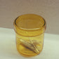 Colour match of HÔTEL827 Overhaze Vanilla mouth blown borosilicate glass jar container with yellow lid.