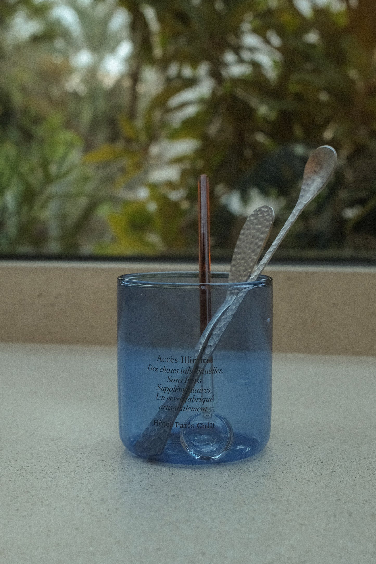 HÔTEL827 blue glass storage jar on kitchen bench-top storing cutlery. 