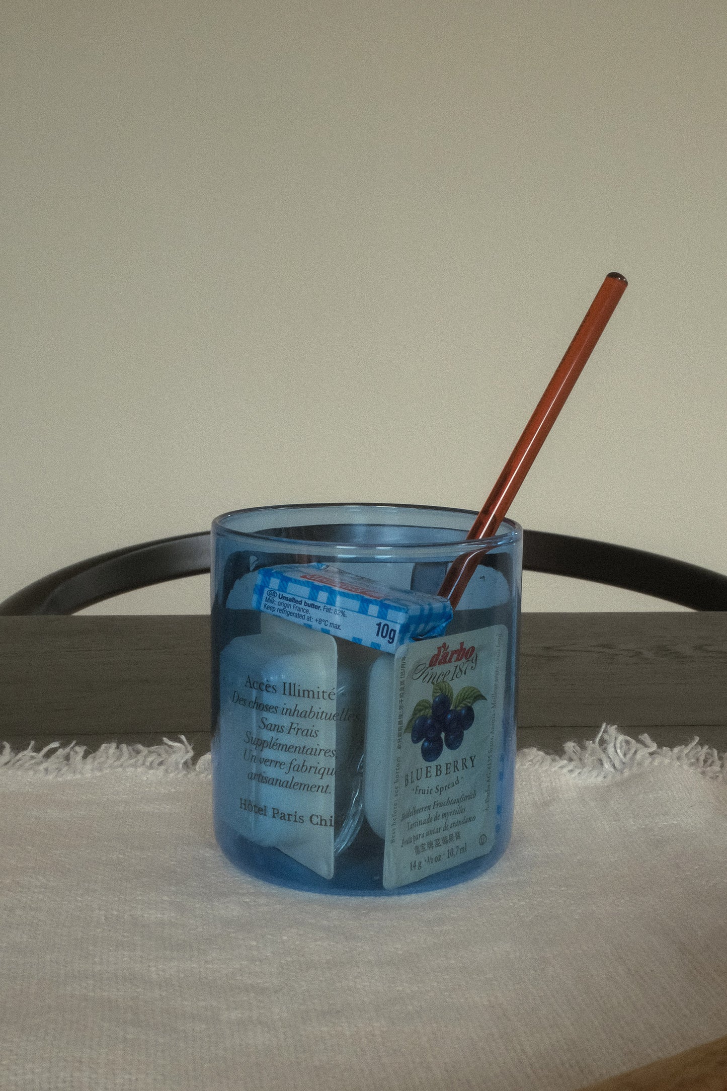 HÔTEL827 blue glass storage jar on dining table storing butters. 