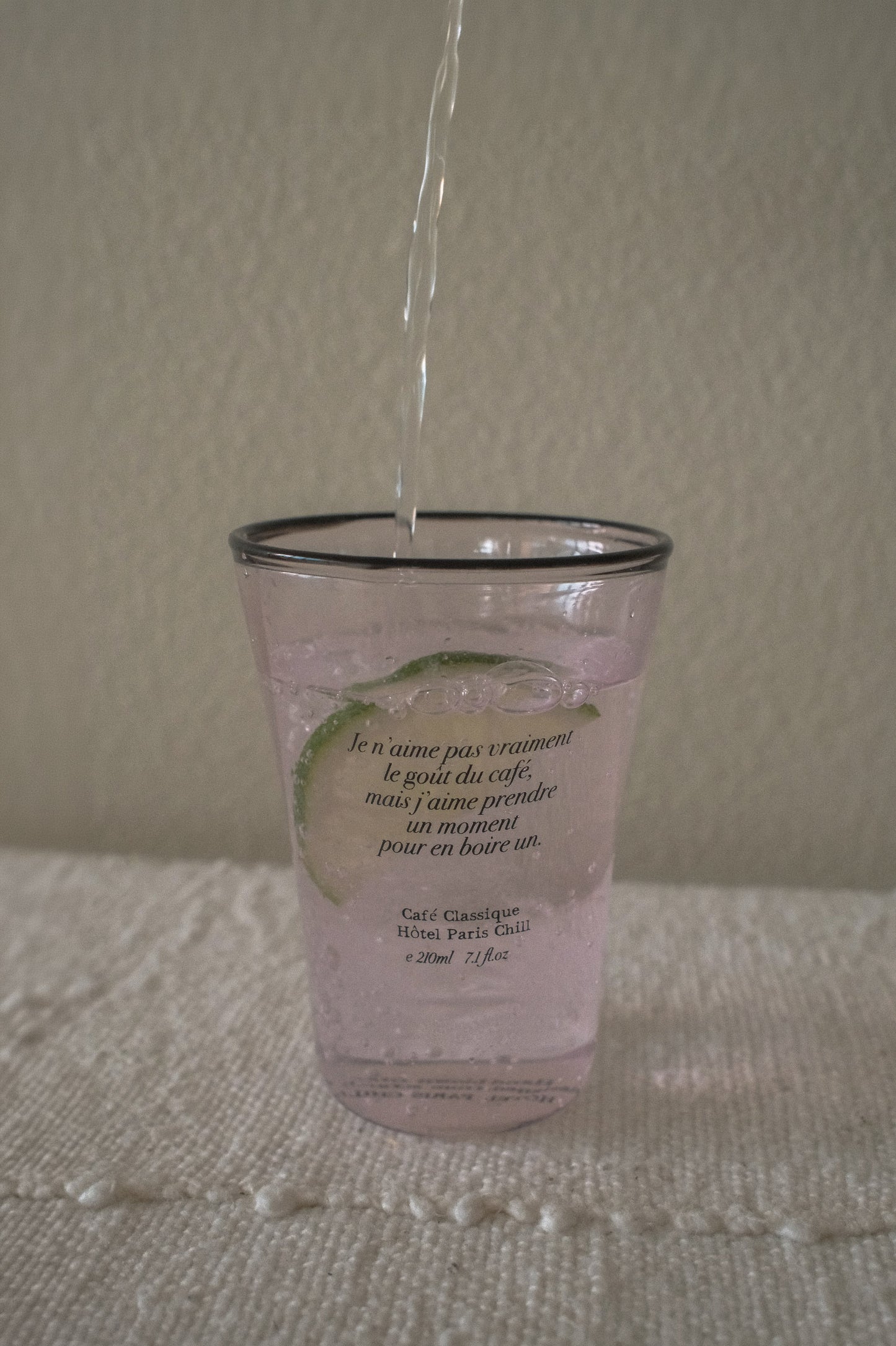 Iced drink served in HÔTEL827 Sun Kissed blush pink glass tumbler on styled dining table