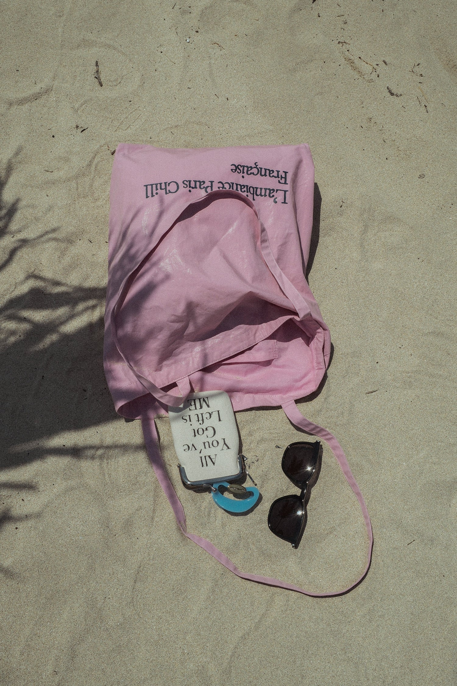 HÔTEL827 Sun Kissed pink canvas tote bag on the sand.