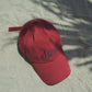 HÔTEL827 Sun Kissed baseball cap in chilli on sand.