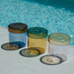 HÔTEL827 glass storage jars nearby a swimming pool.