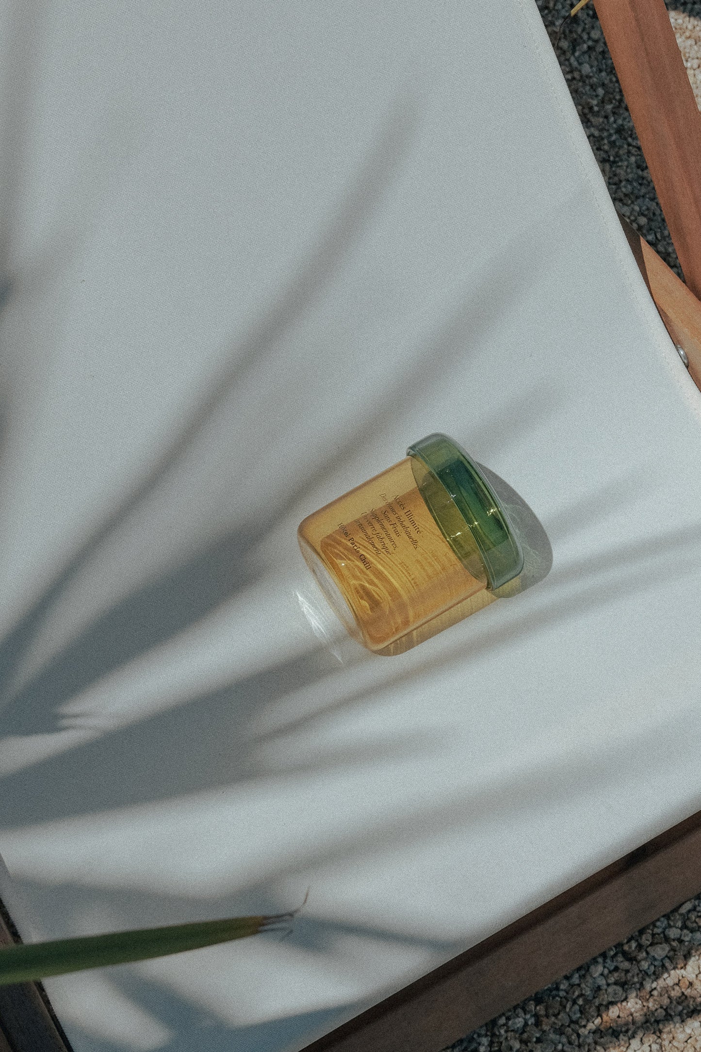 HÔTEL827 vanilla tinted glass storage jar on outdoor chair. 