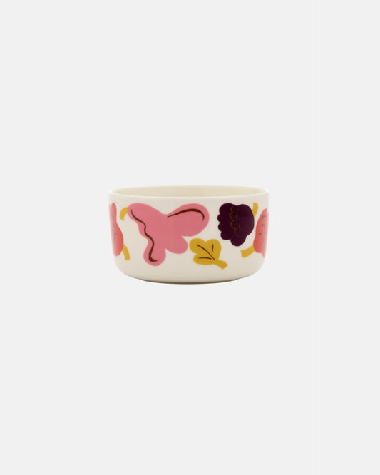 Side-angle view of the Marimekko Oiva 500ml white stoneware bowl featuring the Kukasta Kukkaan abstract floral and leaf pattern in pink, terracotta, and plum.