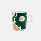 Side-angle view of the Marimekko Oiva 250ml white stoneware mug featuring the iconic Unikko poppy print in dark green, beige, and light sand.