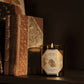 Lit Carrière Frères Chestnut Candle showing a clean-burning cotton wick and vegetable wax.