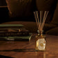 Luxury chestnut scented diffuser on a wooden table, creating a cozy autumn home atmosphere.