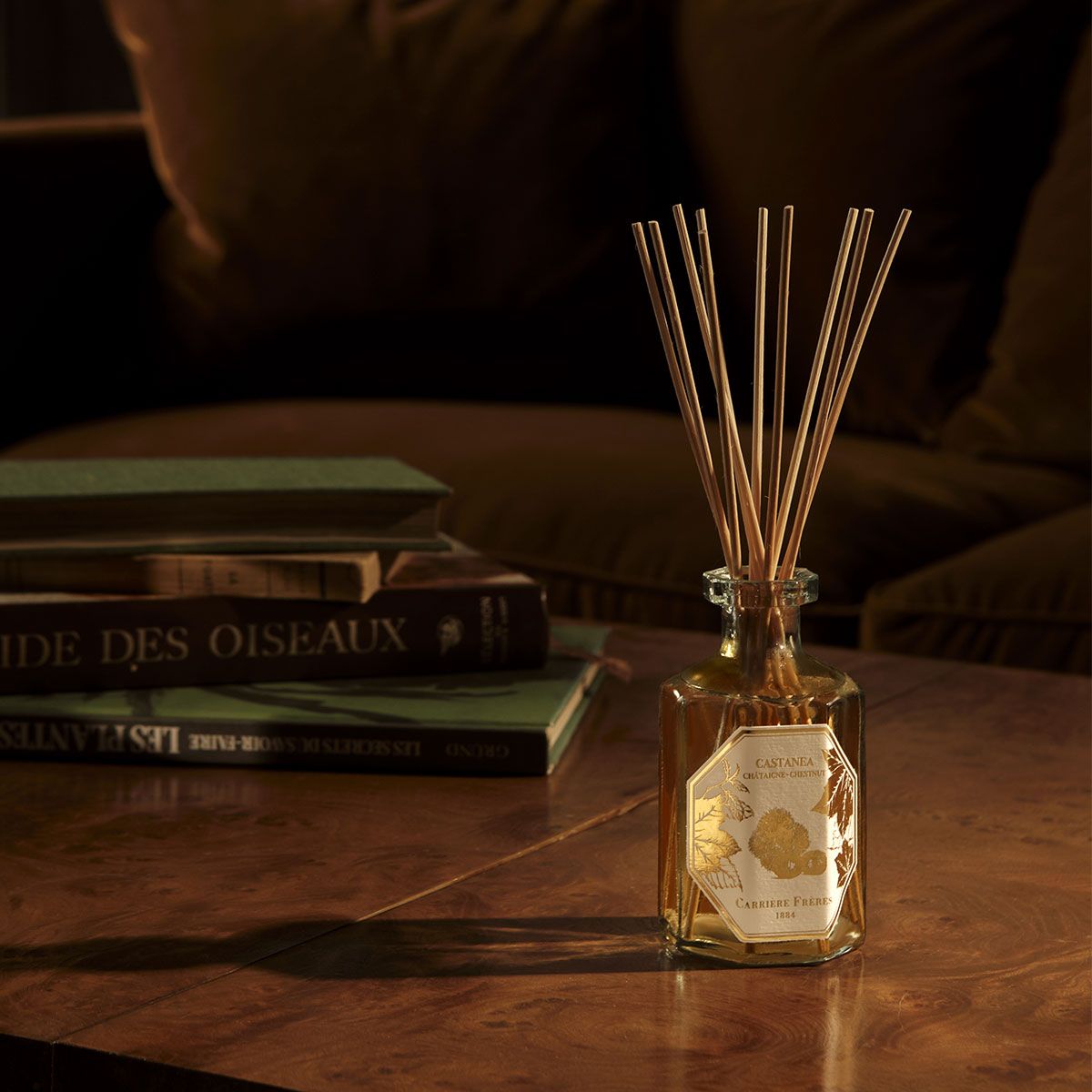 Luxury chestnut scented diffuser on a wooden table, creating a cozy autumn home atmosphere.