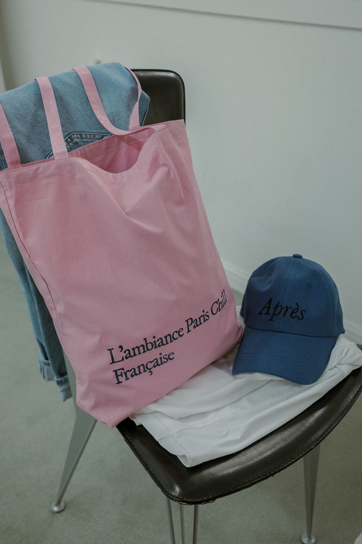 Woman wearing HÔTEL827 Sun Kissed pink canvas tote bag over shoulder, pairing with Hotel827 Sun Kissed baseball cap. 