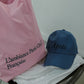 Hotel827 Sun Kissed baseball cap in blue next to the Sun Kissed Bag in pink.