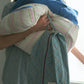 A person carrying Hotel827 cotton travel pouches in different patterns and sizes. 