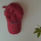 A shot of HÔTEL827 Sun Kissed baseball cap in chilli indoor.