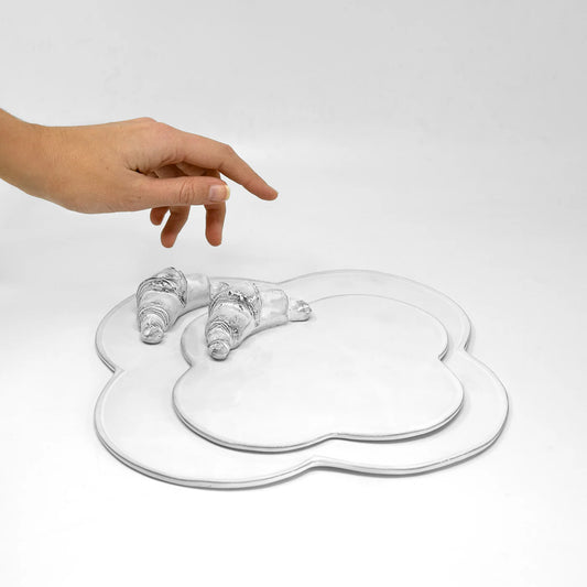 Carron Paris white glazed terracotta croissant plates, in two sizes.