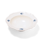 Studio M' Early Bird 170 porcelain bowl featuring a hand-painted blue swallow relief on a scalloped floral rim. A shot taken from the side angle. 