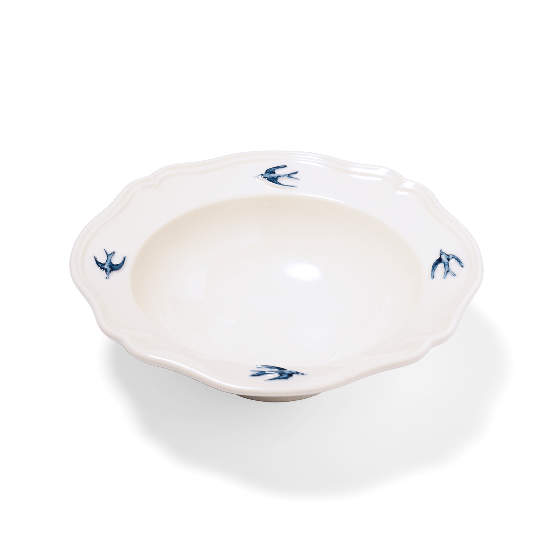 Studio M' Early Bird 170 porcelain bowl featuring a hand-painted blue swallow relief on a scalloped floral rim. A shot taken from the side angle. 