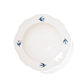 Studio M' Early Bird 170 porcelain bowl featuring a hand-painted blue swallow relief on a scalloped floral rim, a shot from the aerial angle. 