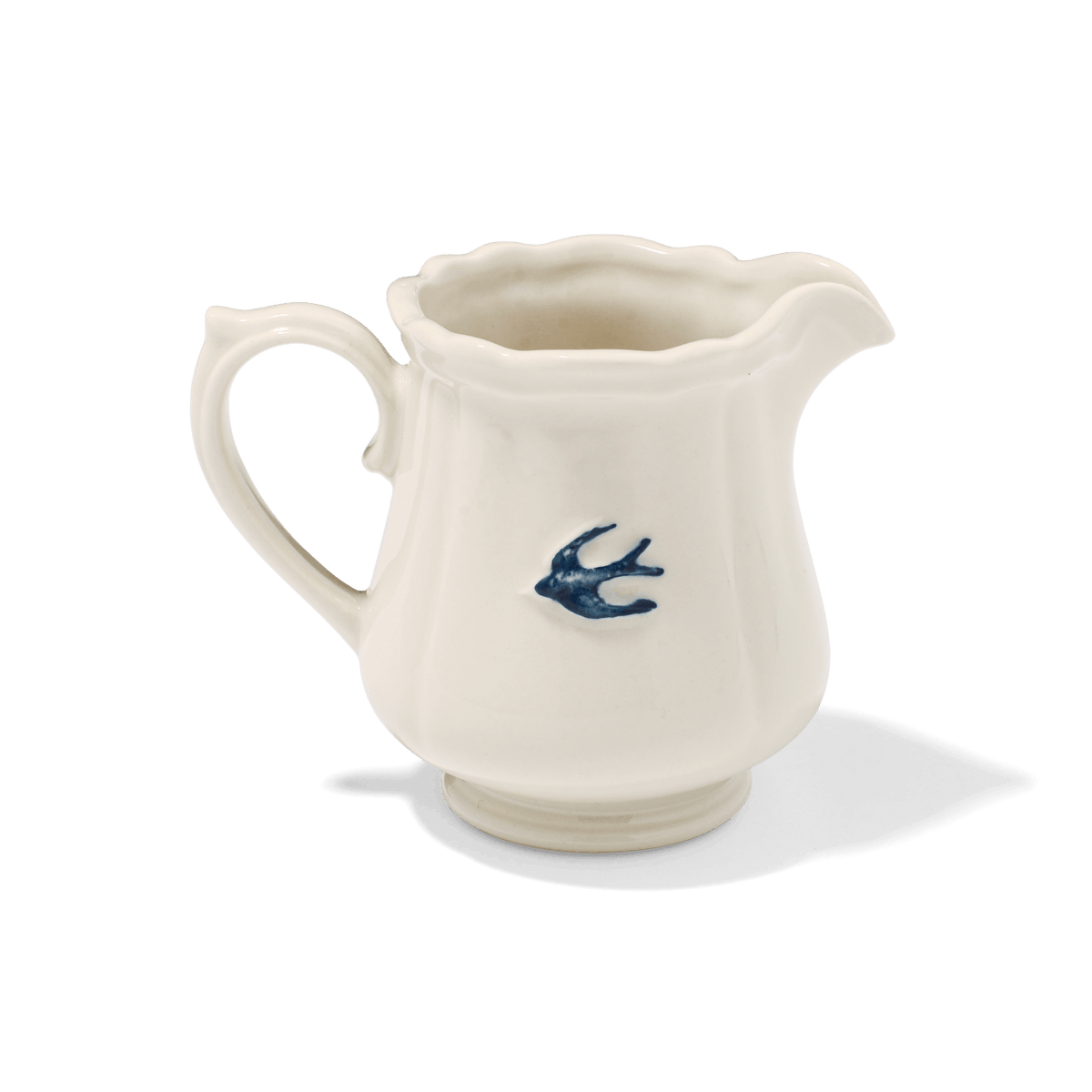 A side view of Studio M Early Bird small creamer.