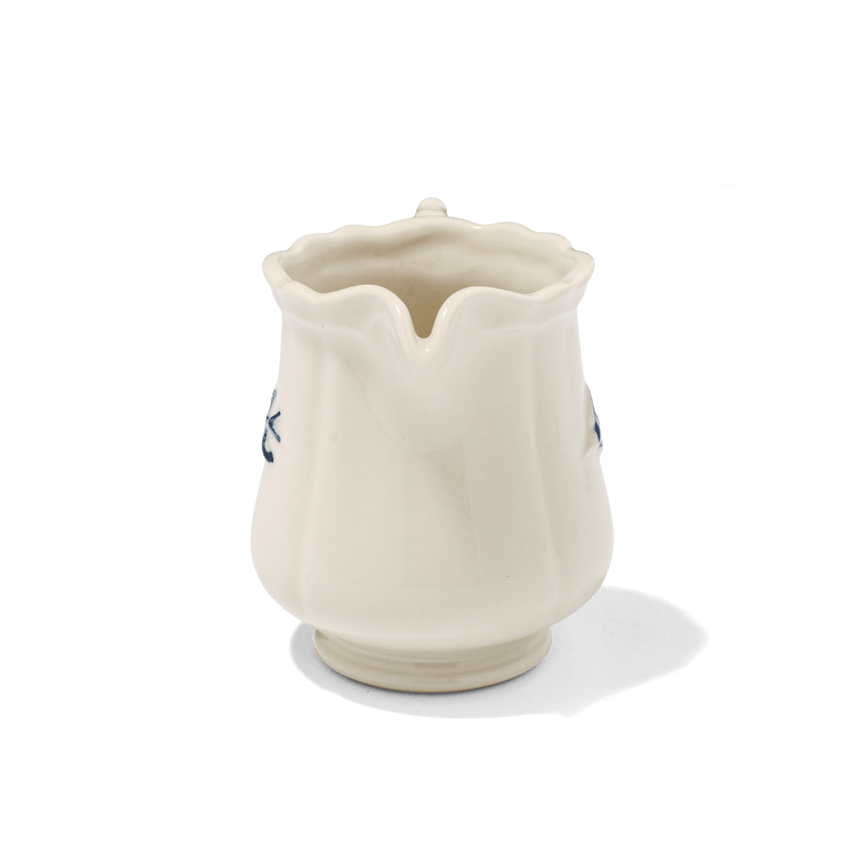 A side view of Studio M Early Bird small creamer from the spout.