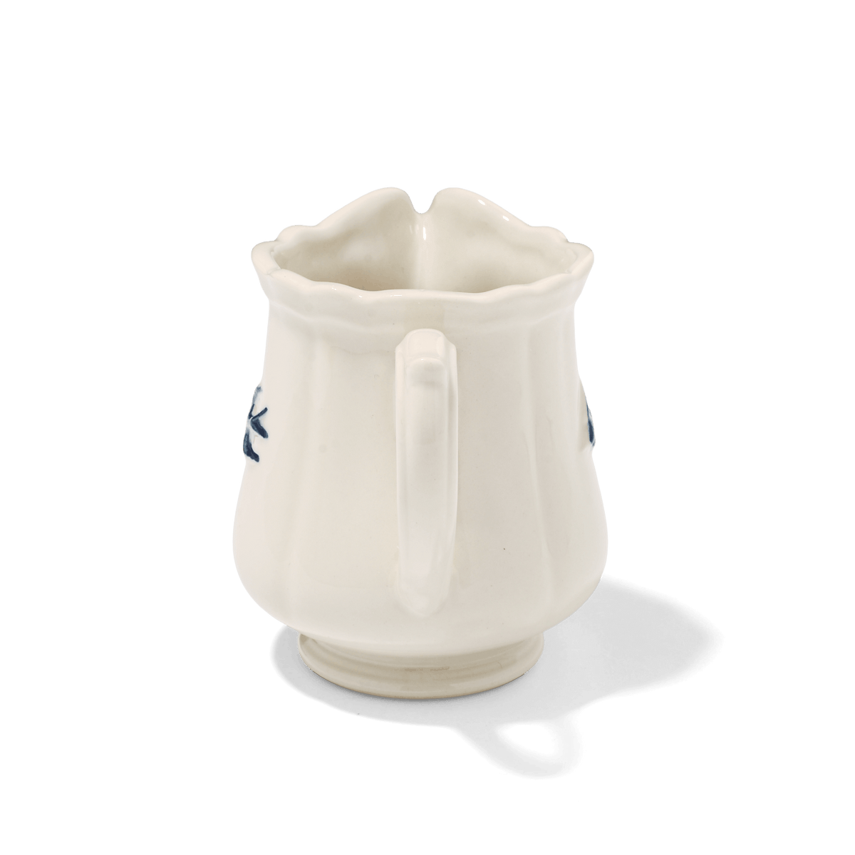 A side view of Studio M Early Bird small creamer from the handle.