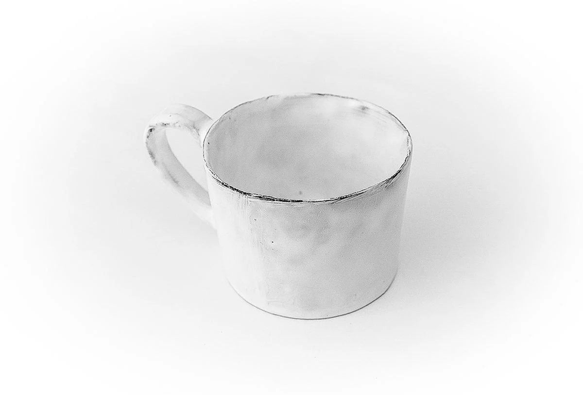 A side shot of Carron Paris ceramic mug with a signature small embossed knot.