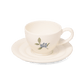 A pack shot of Studio M' Myrtille Cup with Saucer in warm cream ceramic, featuring a rippled edge and a hand-painted, thickly glazed vintage blueberry and leaf motif.