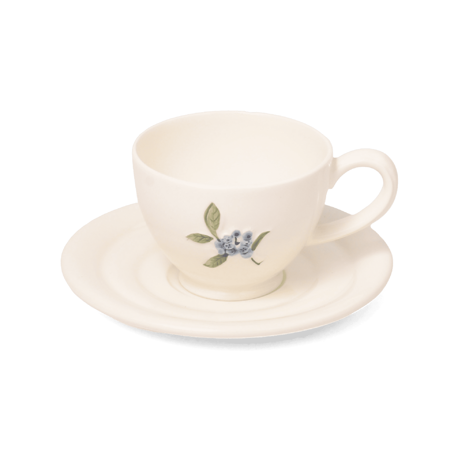 A pack shot of Studio M' Myrtille Cup with Saucer in warm cream ceramic, featuring a rippled edge and a hand-painted, thickly glazed vintage blueberry and leaf motif.
