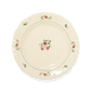 A pack shot of Studio M' Rosier Plate 24cm in a warm, subtle beige glaze, featuring a vintage-inspired red rose motif and an elegantly tiered, hand-painted rim.