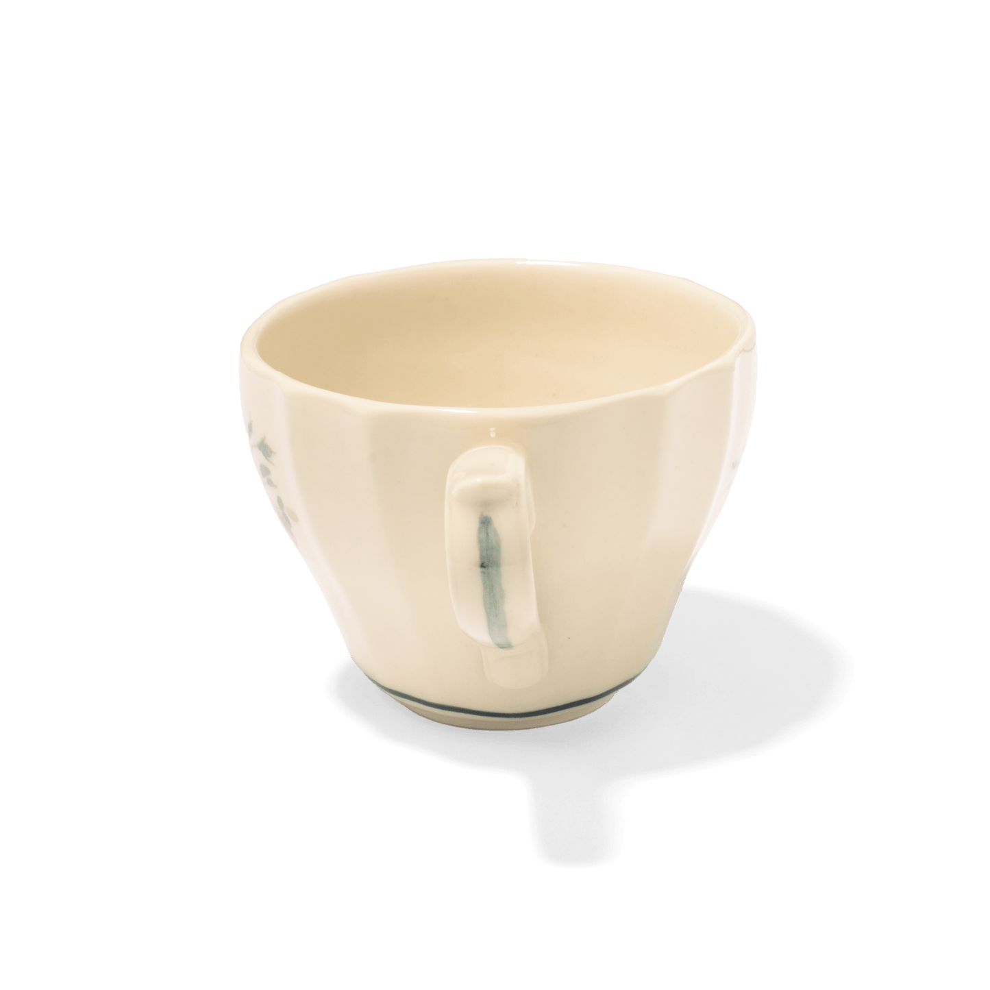 A pack shot of Studio M' Rosier Mug in a warm, subtle beige glaze, from the handle side.
